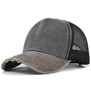 Detail showing vintage washed trucker hat with distressed brim and breathable mesh back