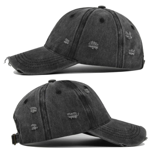 Side view detail of distressed washed charcoal baseball cap with ripped denim holes