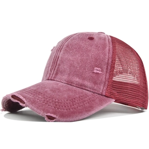 Macro detail of distressed washed fabric and breathable mesh on the vintage baseball cap