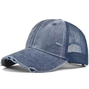 Close-up of distressed denim baseball cap with mesh back and vintage washed finish
