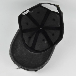Detail view of cotton baseball cap interior showing stitching and 100% cotton wash label
