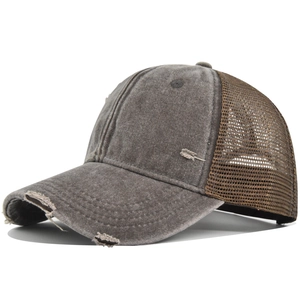 Close-up of distressed brim details on a vintage grey and brown trucker baseball hat