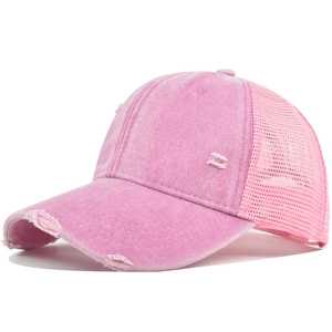 Detail of pink washed cotton baseball cap with vintage distressed holes and mesh back