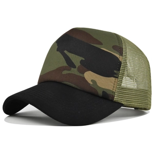 Detailed close-up of camouflage trucker hat showing green mesh and black curved brim