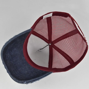 Detail shot of blue washed denim and red mesh trucker cap with adjustable snapback