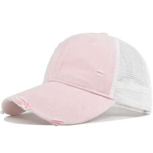 Detailed macro view of distressed pink twill fabric and white breathable mesh on baseball cap