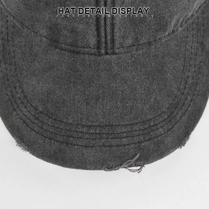 Detailed macro view of distressed holes and reinforced stitching on a vintage baseball cap