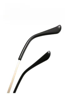 Detail of lightweight golden metal temple and black ergonomic curved tips of sunglasses