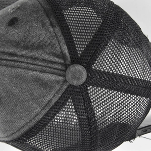 Top view detail of a vintage washed cotton trucker hat with breathable mesh and button