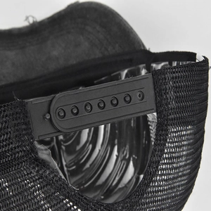 Detail of adjustable snapback closure and breathable black mesh on the trucker hat