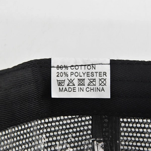 Detailed view of the wash label inside the black cotton baseball cap showing 80% cotton material