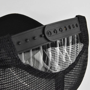 Detail view of the black mesh trucker hat with an adjustable snapback closure strap