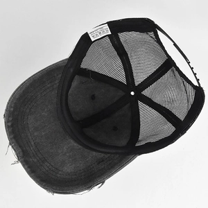 Detail view of charcoal grey distressed trucker hat showing mesh back and adjustable strap