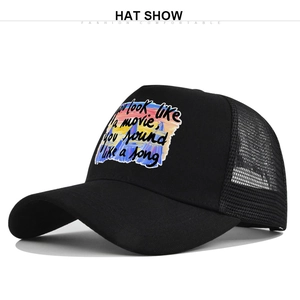 Détail de la casquette trucker noire avec filet et impression de paroles sur le devant