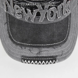 Macro detail of vintage washed grey baseball cap with New York 3D embroidery