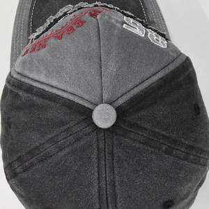 Close-up of vintage washed baseball cap featuring 3D embroidery and distressed ripped details