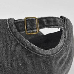 Detail of adjustable metal buckle and washed fabric texture on the vintage baseball cap