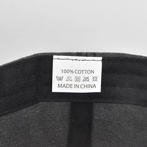 Detailed view of the 100% cotton fabric tag and washing instructions for this baseball cap