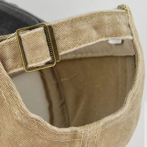 Detailed view of the vintage toucan baseball cap featuring an adjustable bronze metal buckle