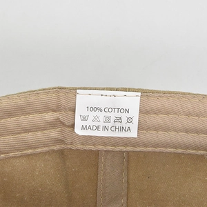 Close-up of the internal 100% cotton material label on the vintage eagle baseball cap