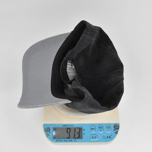 Detail shot of vintage baseball cap weighing 91.3g on a scale to show its quality