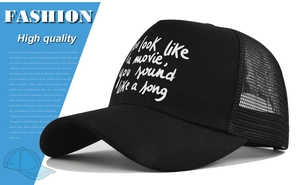 Detail of black mesh trucker hat showing the breathable back panel and adjustable strap