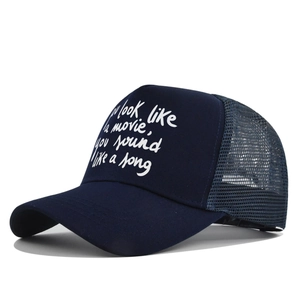 Detail of navy trucker hat with white script quote and breathable mesh back panel