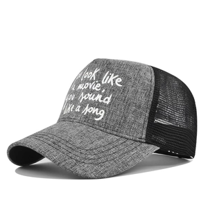Close-up of gray mesh trucker hat with You look like a movie printed quote on front