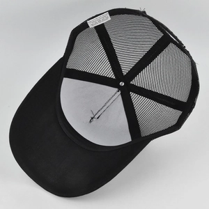 Detail view of the breathable mesh back and cotton sweatband inside the black baseball cap