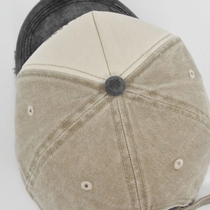 Detail of vintage washed khaki cotton baseball cap showing top stitching and air vents