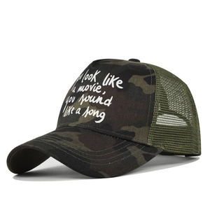Detail view of camouflage trucker hat with white screen-printed quote and mesh back