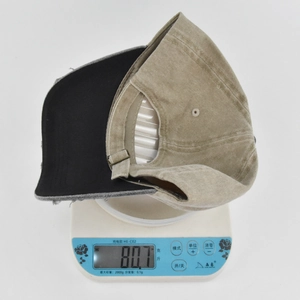 Weight measurement of khaki corduroy baseball cap showing 80.7g on electronic scale