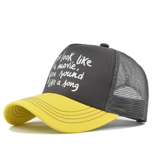 Detail view of mesh trucker cap with You look like a movie song print in gray and yellow