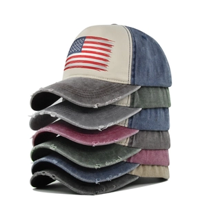 Vintage US flag baseball caps stacked in multiple colors with distressed denim brims
