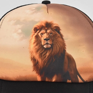Close-up of a black baseball cap featuring a detailed lion print in sunset colors