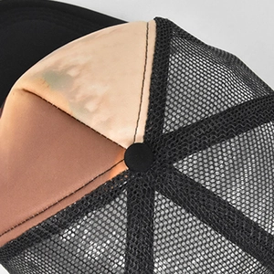 Close-up of black mesh back and gradient foam panel on breathable animal trucker hat