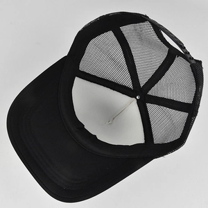 Detail of breathable black mesh trucker hat showing adjustable snapback closure
