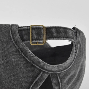 Detailed macro view of dark grey washed denim baseball cap with ponytail cross back design