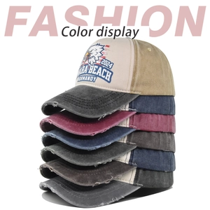Detail view of washed distressed baseball caps in multiple colors with eagle print