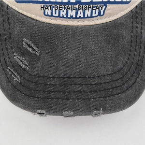 Detailed close-up of distressed denim brim with Normandy embroidery and vintage stitching