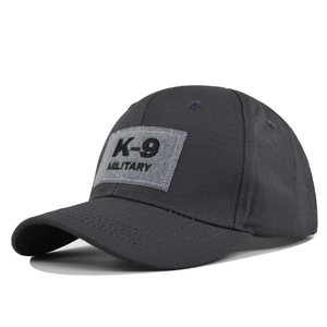 Close-up of military K-9 embroidery on dark gray ripstop tactical baseball cap