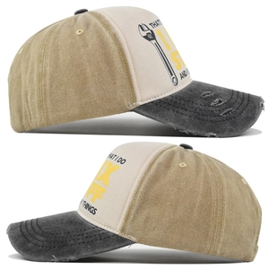 Detail view of washed vintage baseball cap showing distressed brim and printed graphics