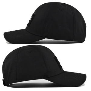 Side view of a black tactical baseball cap made of durable ripstop fabric with velcro