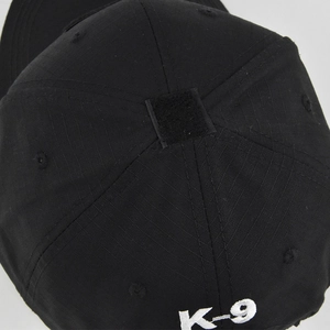 Detail of black ripstop tactical baseball cap featuring square velcro patch and K-9 embroidery
