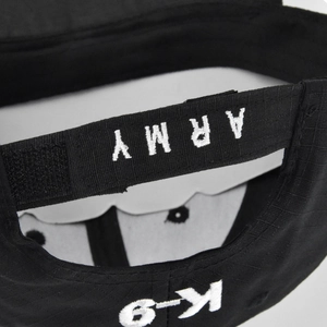 Detail of adjustable hook-and-loop strap with ARMY and K-9 embroidery on black tactical cap