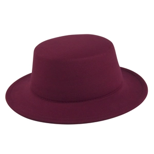 Macro view of burgundy wool felt boater hat showing fine texture and flat brim