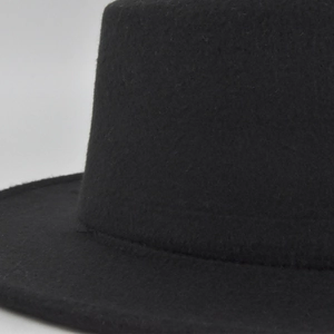 Close-up of the black felt fabric texture and brim seam on the wool jazz fedora hat