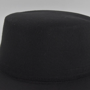 Detailed close-up showing the fine texture of the black wool felt jazz hat crown and brim