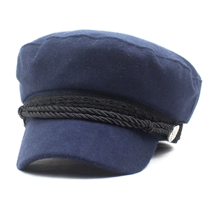 Navy blue wool baker boy hat for women featuring a black braided cord and metal side buttons