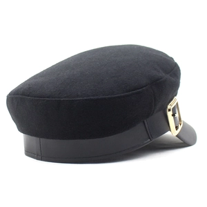 Detail shot of the black wool baker boy hat with a PU leather strap and gold metal buckle